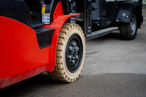 Red industrial forklift with beige solid tire and steel rim Stock Photos