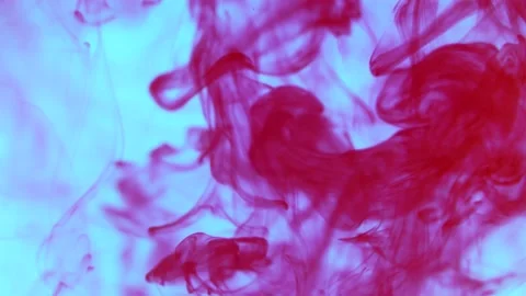 Red ink in a blue water background slow motion Video stock 238922600