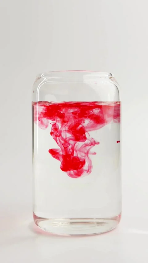 Red ink drop falling into water and swirling slowly Stock Footage 331774619