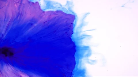 Red ink drop splashing in blue ink mixing and swirling together in slow motion Stock Footage 102755309