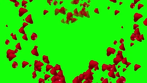 Red ink dropping into clear water creating swirling clouds on a vibrant green Stock Footage 338438630