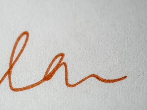 Red ink flows across textured white paper Stock Photos
