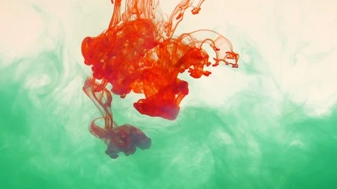 Red ink flows into green ink Stock Footage 89906031