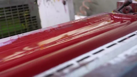 Red ink rollers operating inside offset printing press mechanism Stock Footage 321540014
