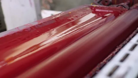Red ink rollers operating inside offset printing press mechanism Stock Footage 334776386