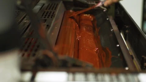 Red ink spread onto a printing press Stock Footage 130144614