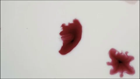 Red ink in white paint Stock Footage 72805814