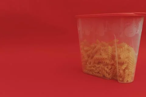 Red jar with macaroni on red background, monochrome Stock Photos