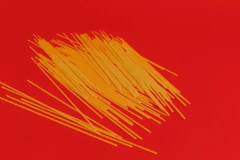Red jar with macaroni on red background, monochrome Stock Photos