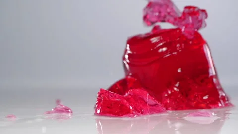 Red jelly falling down. Сlose up slow motion. Stock Footage 153882830