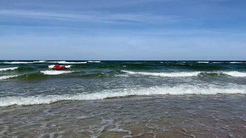 Red jet ski on moving surface and waves of Baltic sea. Stock Footage 138242209