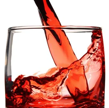 Red juice is poured into the glass Stock Photos