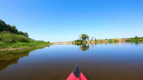  Red  Kayak on calm blue river with algae and grass. Boating team Stock Footage 166798466