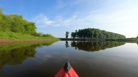 Red kayak went down a past picturesque river. River travel landscape Stock Footage 166388237