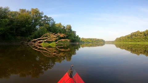 Red kayak went down a river and past picturesque tree. River travel landscape Stock Footage 166383475