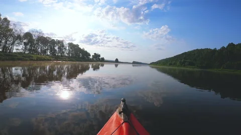 Red kayak went down a river with sun reflection. River travel landscape Stock Footage 166802047