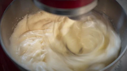 Red kitchen mixer working and beating egg with sugar. Sweet food. Stock Footage 302650988