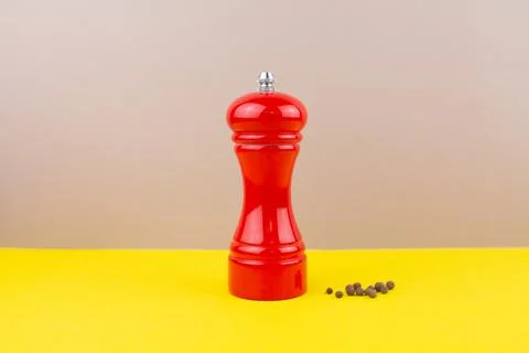 Red kitchen pepper shaker for ground pepper on the table Stock Photos