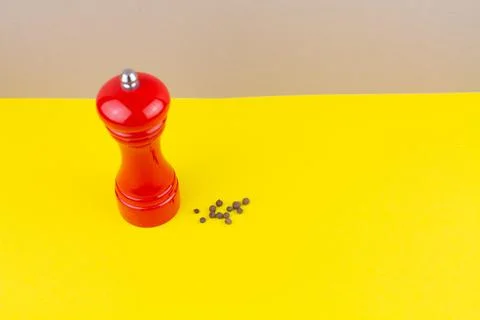 Red kitchen pepper shaker for ground pepper on the table Stock Photos