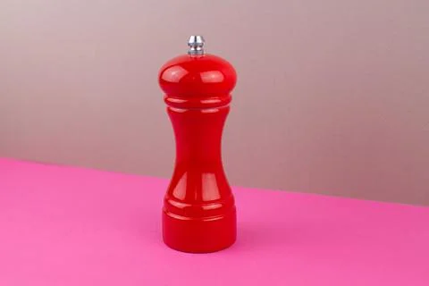 Red kitchen pepper shaker for ground pepper on the table Stock Photos