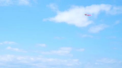 Red kite flying against blue sky. White clouds. Stock Footage 113288055