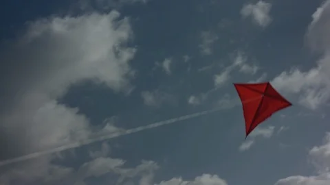 Red kite flying into the sky with clouds - Medium Shot | Color Corrected Stock Footage
