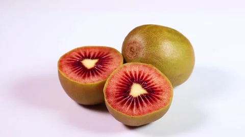 Red kiwi fruit on white background, rotating Video stock 310028613