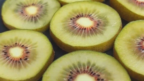 The red kiwi slices in a circular motion Stock Footage 256083630