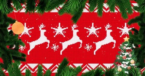 Red knitted panel showing white reindeer and star motifs with fir branches Stock Photos