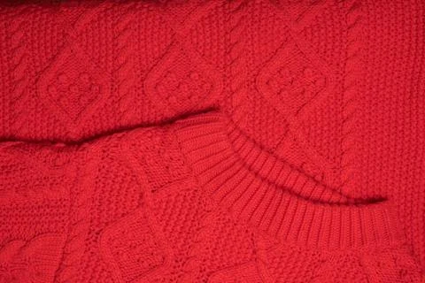 Red knitted texture with a pattern Stock Photos