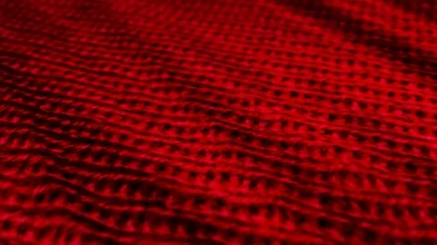 Red knitted wool background. Fabric sweater, pullover is waving. Stock Footage 108971177