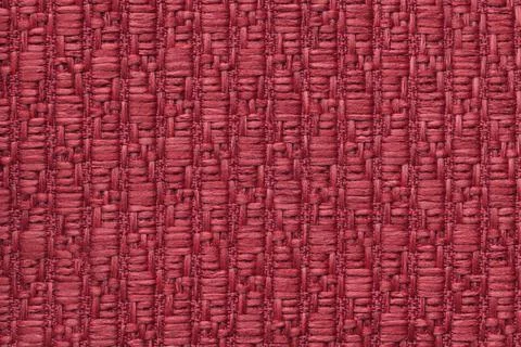 Red knitted woolen background with a pattern. Texture of textile closeup. Stock Photos