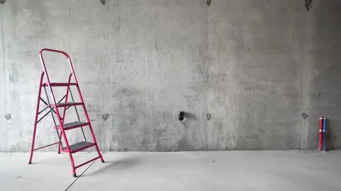 Red ladder against concrete wall of room interior under constraction Vídeos de archivo 113314341