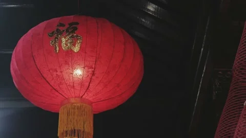 Red lamp with lantern style lampshade, hanging during Chinese New Year Stock Footage 134281652