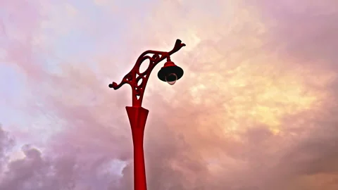 Red Lamp Post Against a Sunset Cloudy Sky Stock Footage 275840186