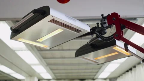 Red lamps for drying the machine after painting or ceramics car body. Repair Stock Footage 136274104