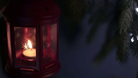A red lantern with a candle on a background of Christmas lights Stock-Footage 70394191