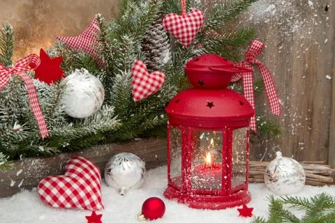 Red lantern with candlelights an checked heards for a christmas decoration in Stock Photos