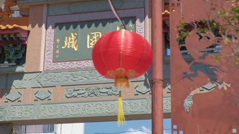 A red lantern hanging in front of Buenos Aires Chinatown arch at lunar new year Stock-Footage 124023376
