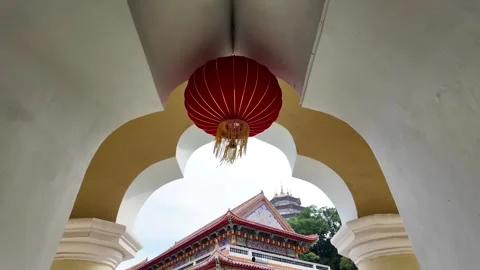 A red lantern hangs from the ceiling of a building Stock Footage 318094906