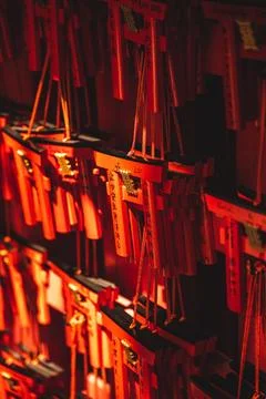 Red lanterns are lined up and hung from the ceiling and on the side Stock Photos