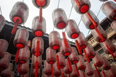 Red lanterns hang in rows, glowing softly Stock Photos