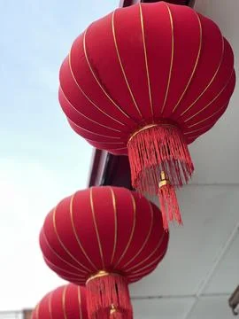 Red Lanterns Hanging from the Ceiling in Daylight Stock Photos
