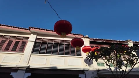 Red lanterns hanging over heritage shophouses in George Town Stock Footage 332738506