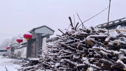 Red Lanterns Hanging in Snowfall Creating a Festive New Year Atmosphere Stock Footage 333041918