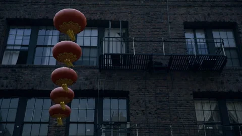 Red Lanterns Vertical String Close-Up Brick Building Fire Escape Video stock 344937261