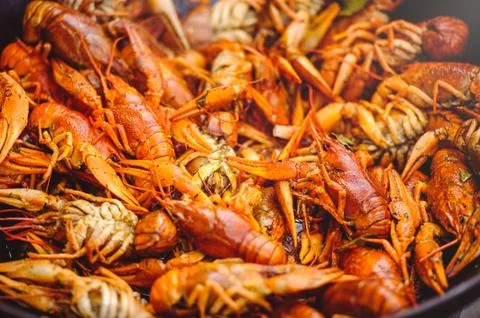 Red large boiled crayfish in hot and apetized cauldron is steam. Stock Photos