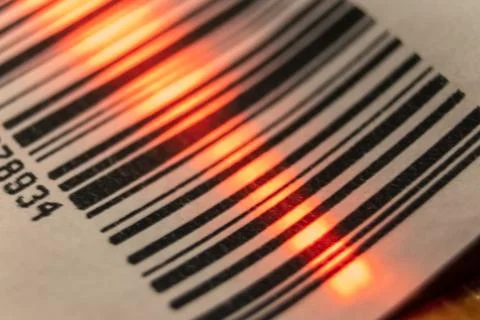 Red laser barcode reader scanning a bar code. Macro bar code. Foto stock