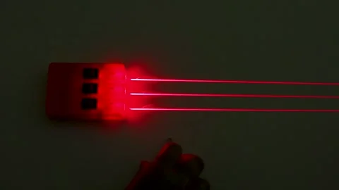 Red Laser Beam Refraction Physics Experiment with Convex Lens Stock Footage 347054474
