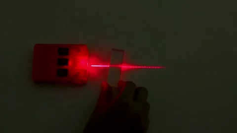 Red Laser Beam Refraction Physics Experiment with Glass Block Stock Footage 347107017